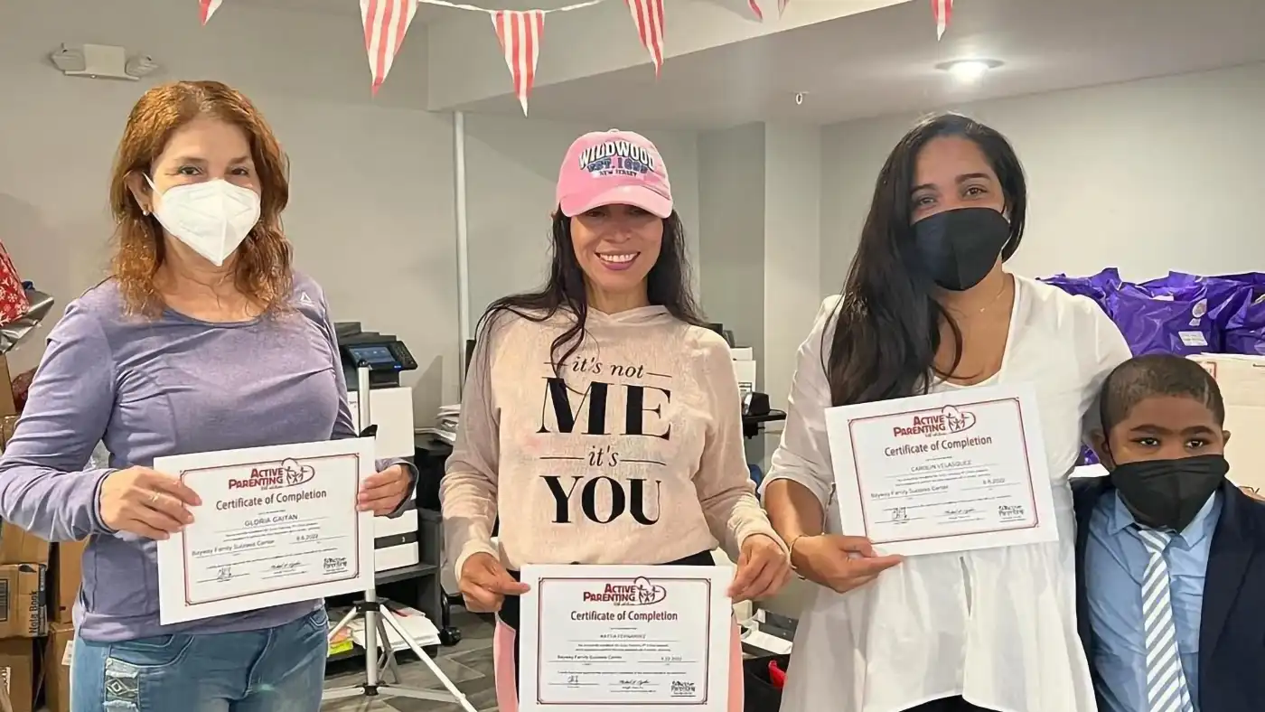 Graduates from the Active Parenting class holding their certificates