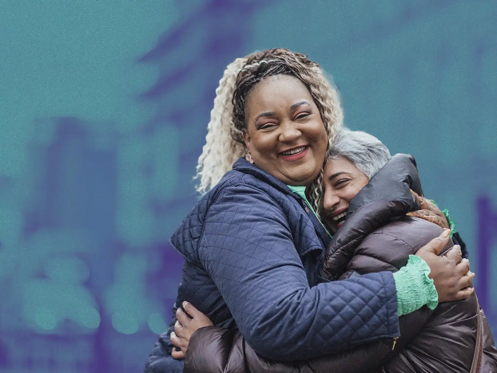 Two women smiling and hugging