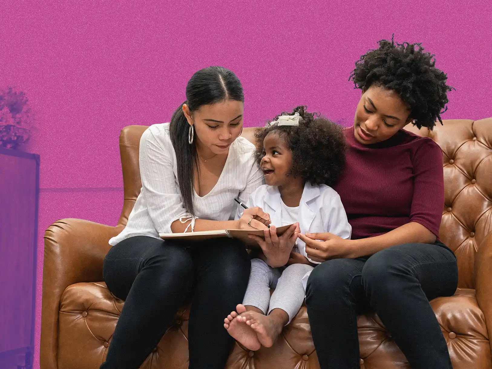 a family with two mom's and a daughter sitting on the couch