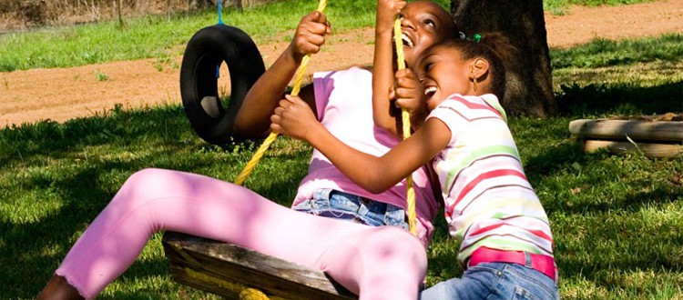 two girls on a swing