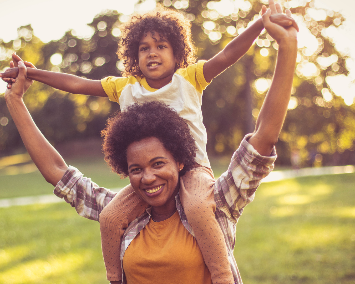 mom with child on her shoulders