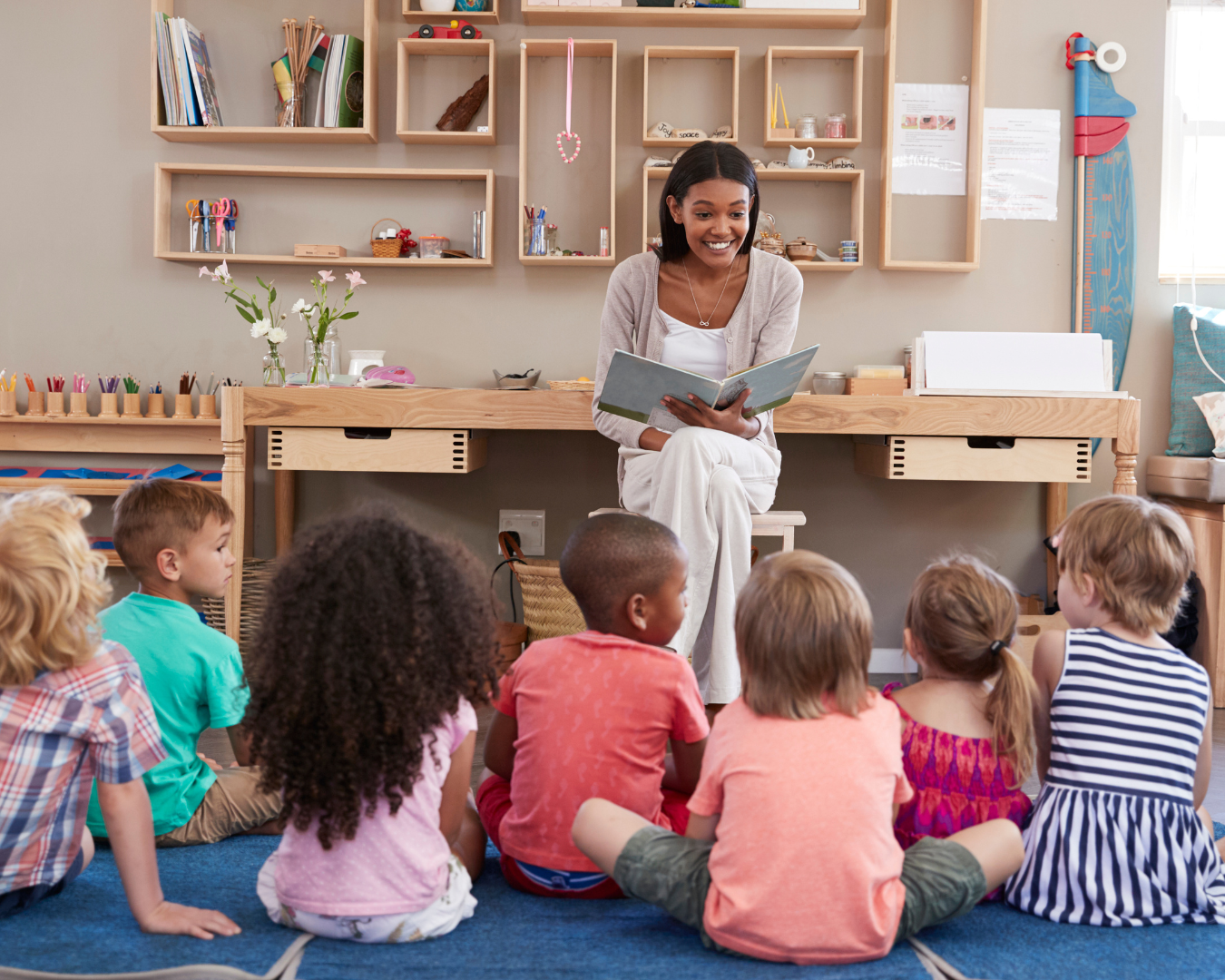 woman reading story to children