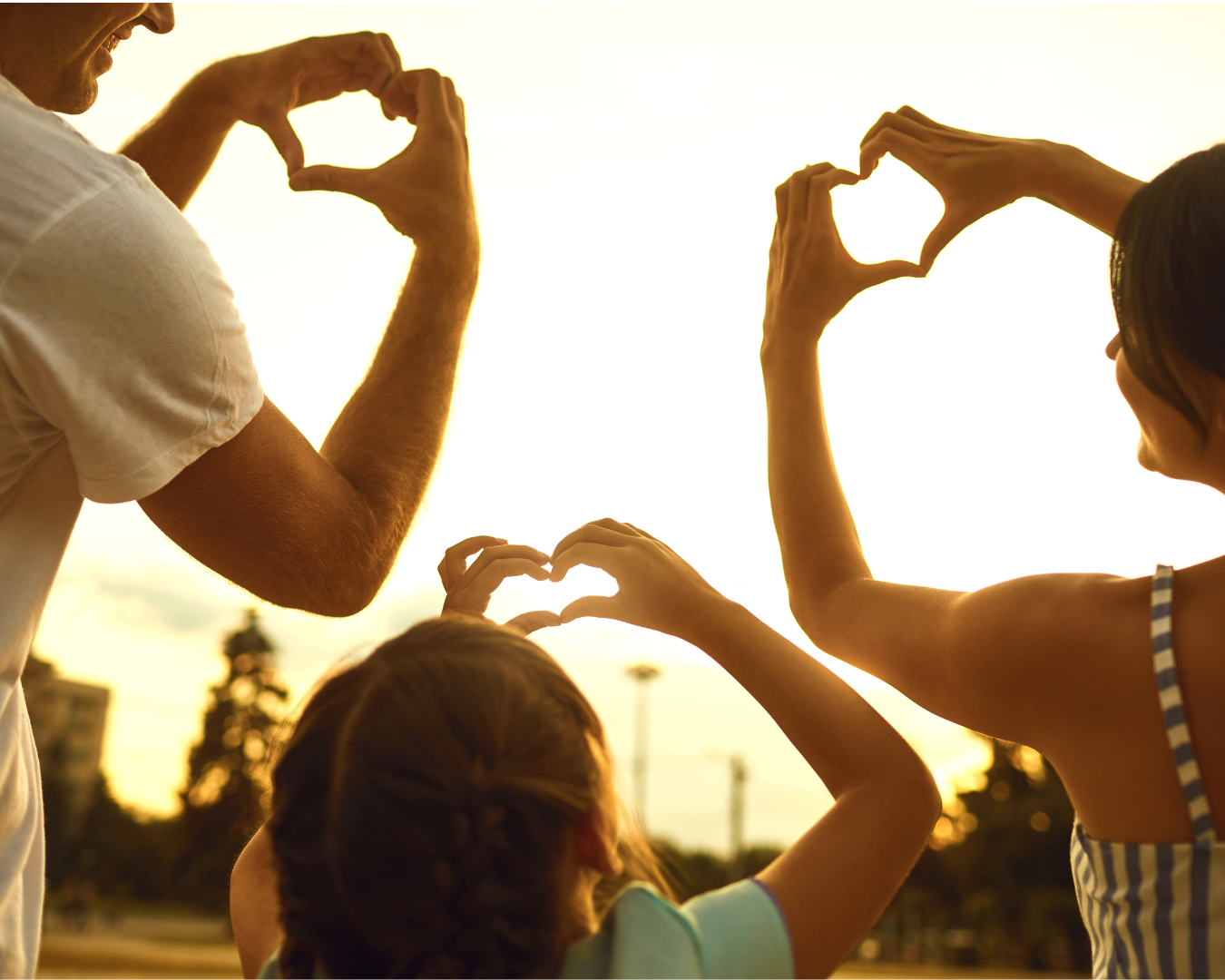 family making hearts with their hands