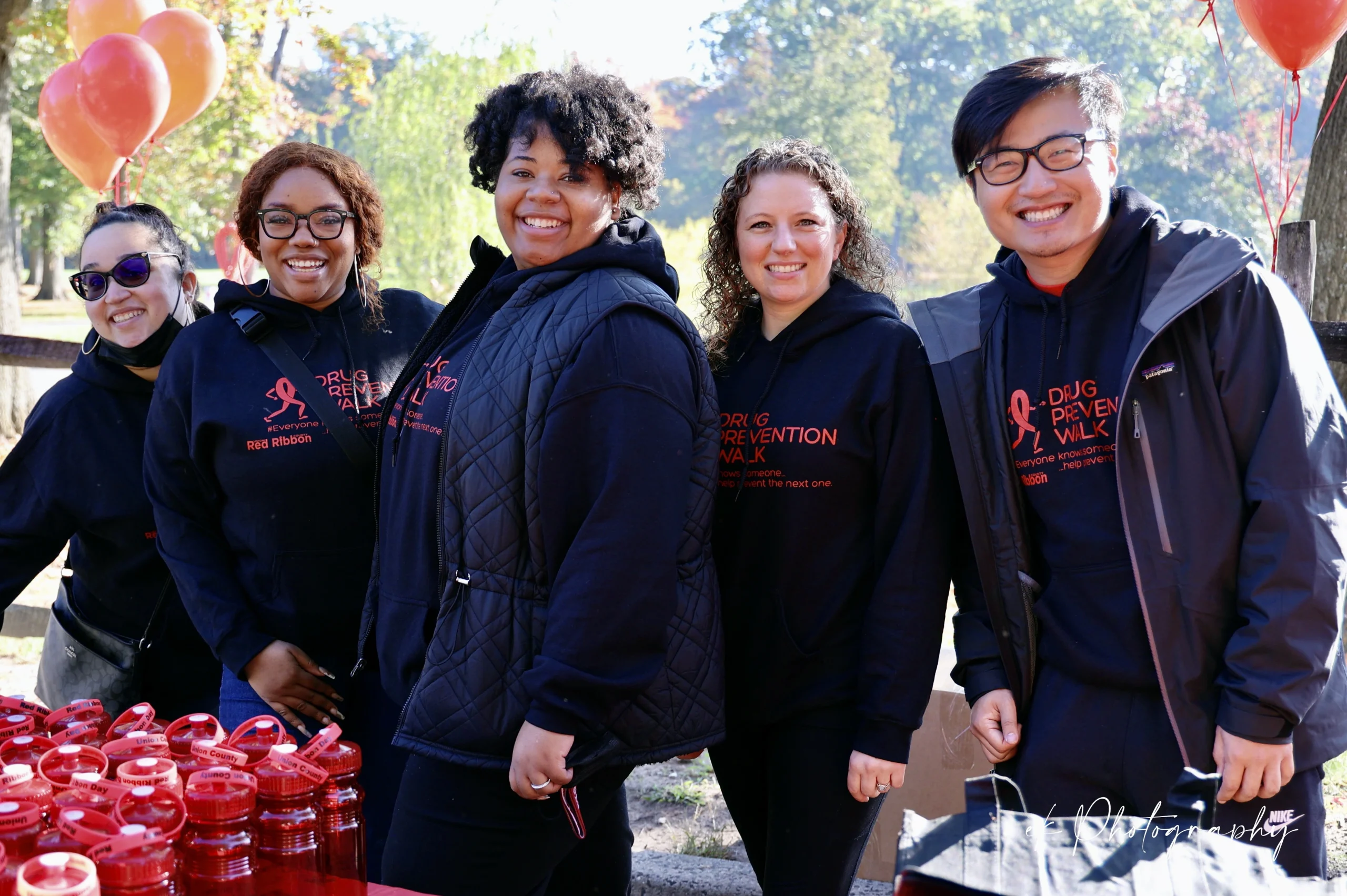 Group of People Smiling at Red Ribbon Day