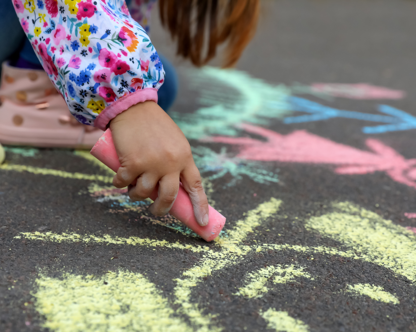 Child using sidewalk chalk