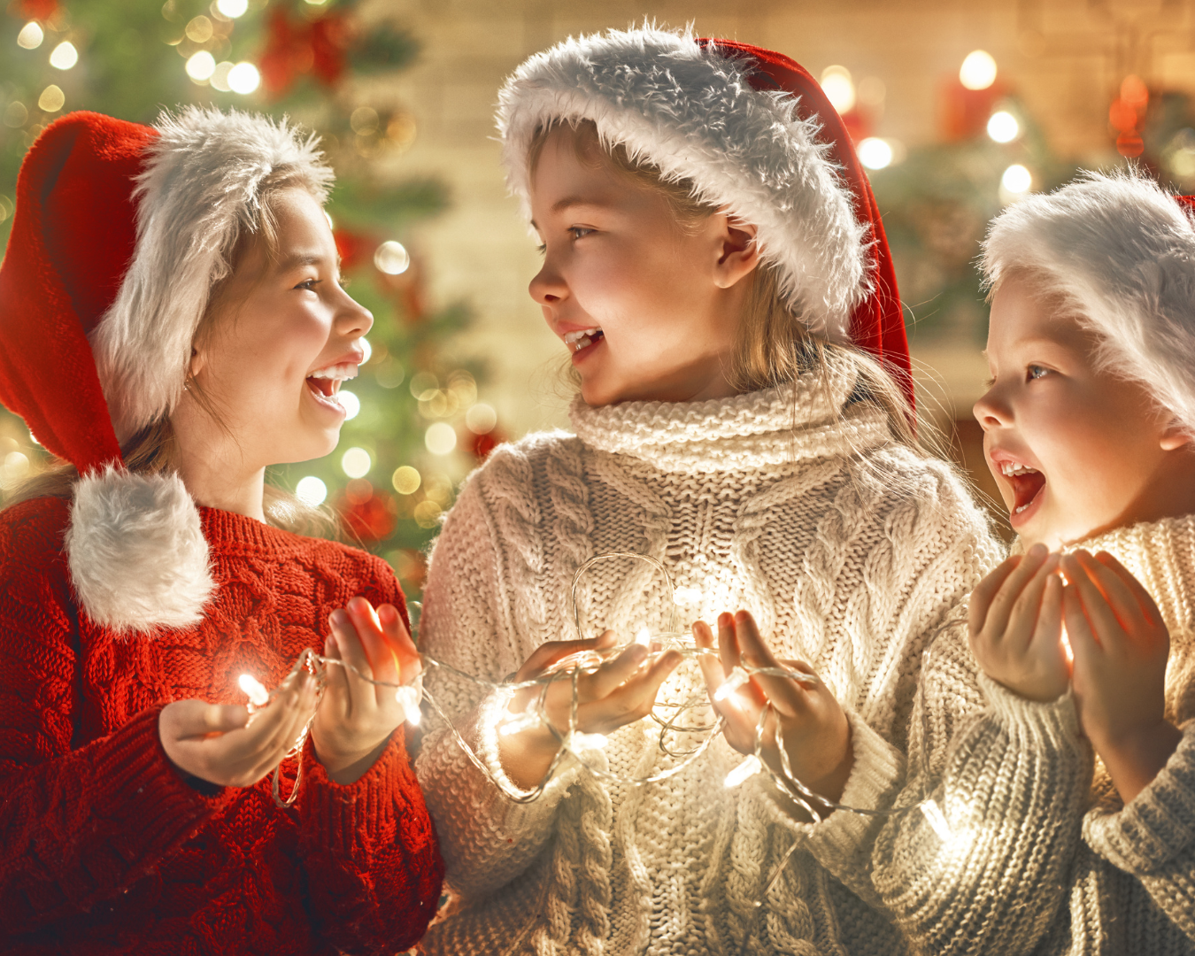 Kids holding Christmas lights